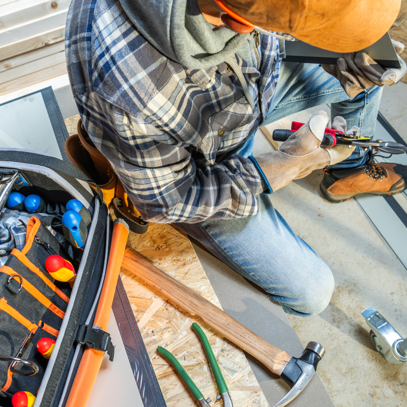 a-construction-worker-uses-a-toolbox-while-install-2025-03-15-18-44-58-utc